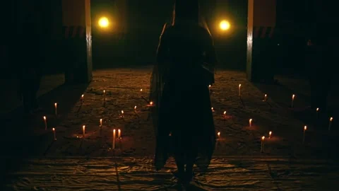 Veiled Figure Walks Through Candle Path Towards Ritual Group (Follow Shot). Stock Footage 232904948
