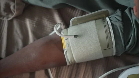 Velcro strap holds cuff securely during blood pressure evaluation at home. Calm Video stock 347523810