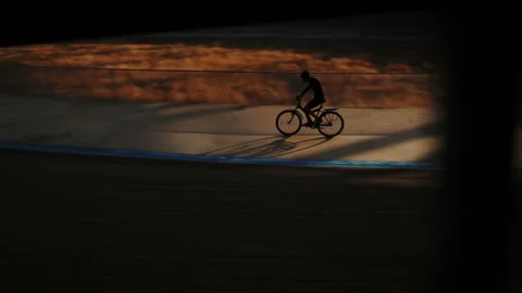 Velodrome cyclist rotates in an empty stadium, light and shadow - 4K  스톡 동영상 147005109