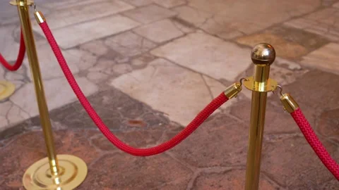 Velvet red ropes fencing zone. Golden ro... | Stock Video | Pond5