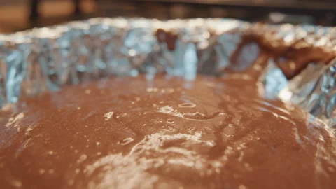 Velvety chocolate mixture gently ripples with waves. Delicate ripples appear as Stock Footage 337463927