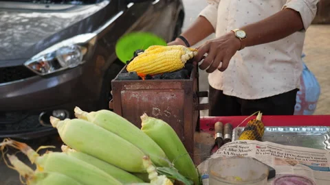 Vender selling corn on traditional barbeque using coal Stock Footage 171094731