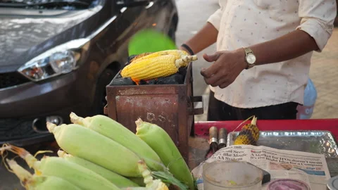 Vender selling corn on traditional barbeque using coal Stock Footage 171094896