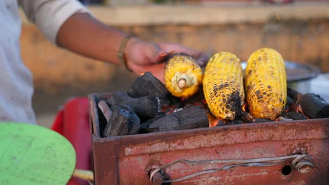 Vender selling corn on traditional barbeque using coal Stock Footage 171094986