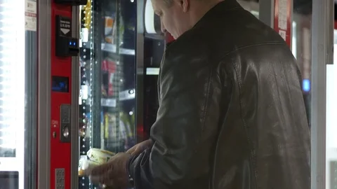 Vending machine operator loads products into slots for sale. Stock Footage 125632223