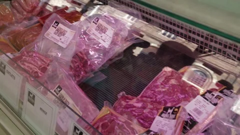 Vendor Arranging Packaged Meat Cuts in Refrigerated Display at Sydney Market Stock Footage 345712176