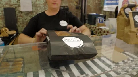 Vendor Bags Fresh Bread for Customer at Indoor Market Counter in Sydney Stock Footage 345711286