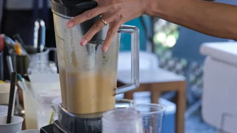 Vendor blending mango shake in blender, closeup Vidéo 338272888