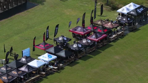 Vendor Booths and Flags Beside Outdoor Firing Range Grounds Stockbeeldmateriaal 337716235