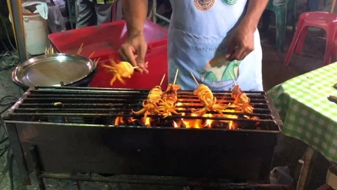 Vendor cooks squids Stock Footage 76843786