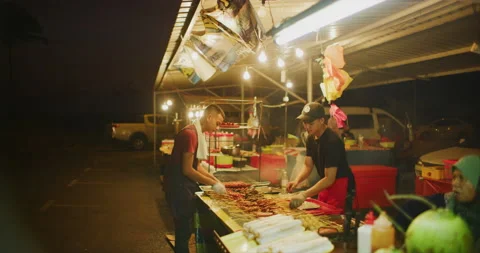Vendor Getting Satay Ready During Evening in the Town of Miri, East Malaysia Stock Footage 147718283