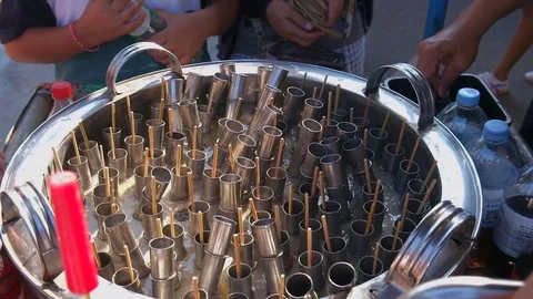 Vendor making local ice cream in shaking ice bucket and sell to customers Stock Footage 120620567