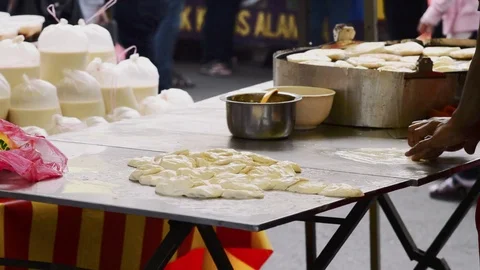 Vendor making murtabak at bazaar Ramadan Stock Footage 92003777