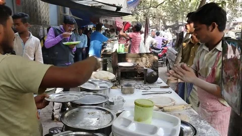 A vendor preparing chapatis over gas at his street stall in India . Stock Footage 81558557
