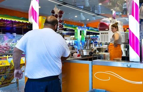Vendor preparing fresh food inside a mobile snack bar truck at a fairground Stock Photos