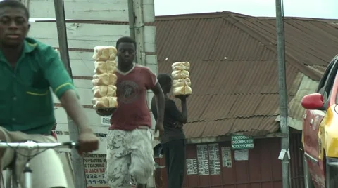 VENDOR RUNS WITH STACK OF BREAD Stock Footage 59734718