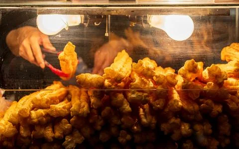 Vendor Selecting Crispy Fried Dough Stick Stock Photos