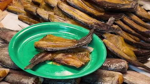 Vendor Selecting Dried Fish Fillets at Traditional Asian Seafood Market Stock Footage 329369381