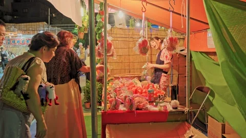 Vendor Selling Bagged Fruit at Temple Night Market Stall, Tokyo, Japan Stock Footage 342710839