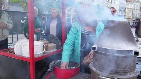 Vendor selling roasted chestnuts in a cold day Aveiro Portugal slow motion Video stock 100348060