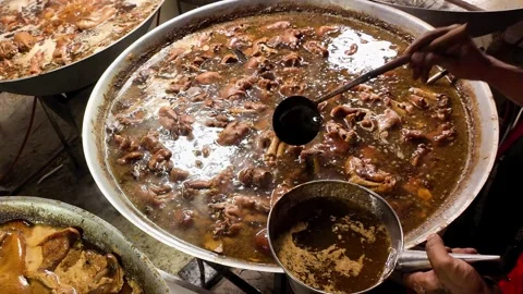 Vendor Serving Braised Duck Offal from Large Pot at Thai Street Food Market Vídeo Stock 340353464