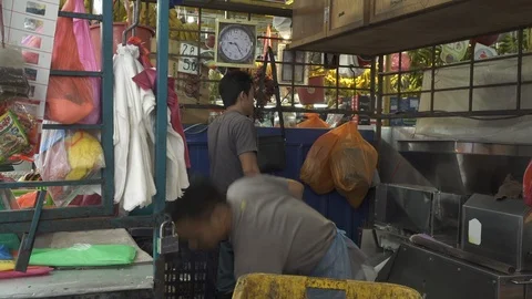 A vendor split the coconut with knife in the market. Stock Footage 122089610