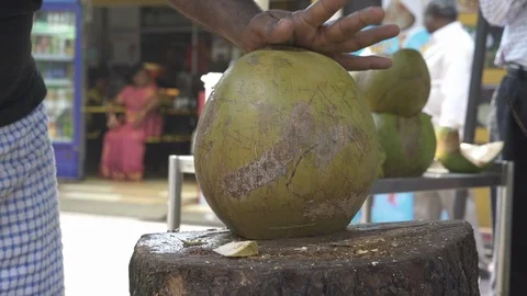 A Vendor Split The Coconut With Knife In The Market. Close up.01 Stock Footage 122557560