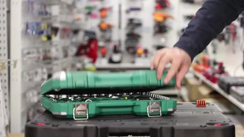 A vendor in a store advertises a set of tools 스톡 동영상 303753366