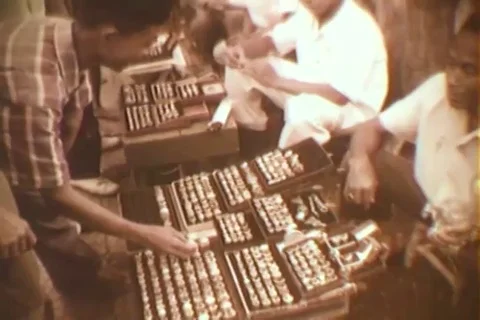 Vendor trying to sell a ring to a customer - 1964 Stock Footage 93003275