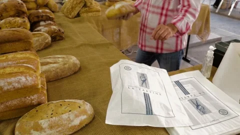 Vendor Wrapping Fresh Bread Loaves at Market Stall in Sydney, Australia Stock Footage 345711609