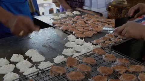 Vendors cooking authentic Thai dessert called Kanom Babin on a hot griddle. Stock Footage 108073610
