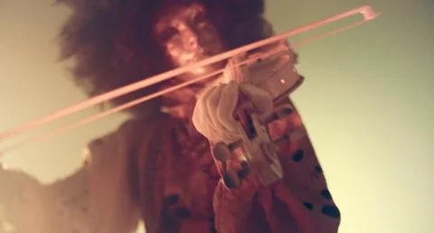 Venetian masquerade violinist playing the violin in smoke and darkness. Stock Footage 70987402