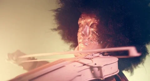 Venetian masquerade violinist playing the violin in smoke and darkness. Stock Footage 70989431