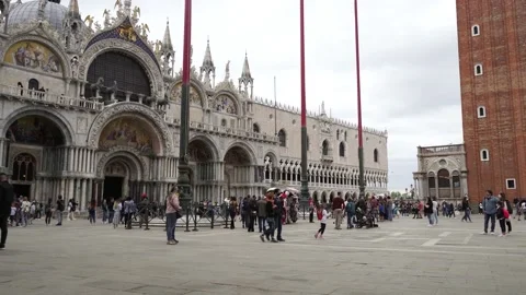 Venic, St. Mark's Square, Basilica di San Marco, tourists pass by Stock Footage 234719484