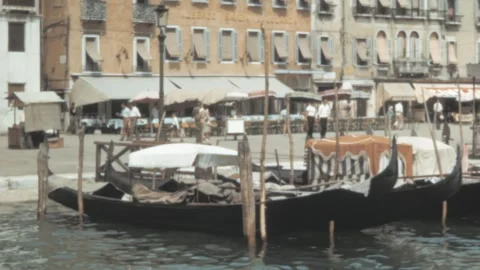 Venice - 1953: Gondolas float along the picturesque canals, pedestrians pass Video stock 291017497