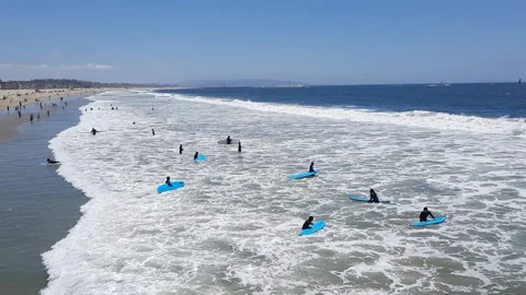 Venice Beach California beach Surf School surfers surfing the waves Stock Footage 196015553