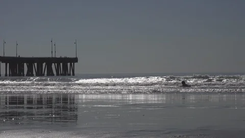 Venice Beach small waves break. Children play, people walk by. Stock Footage 121251194