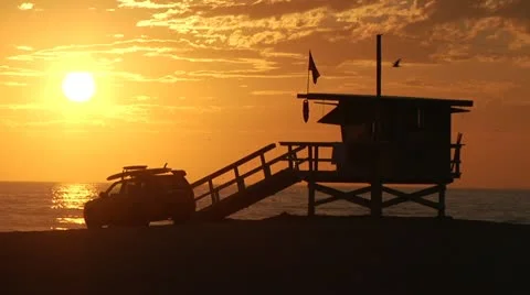 Venice Beach Sunset Slow motion Zoom out from lifeguard tower Stock Footage 19386360