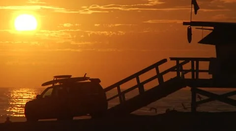 Venice Beach Sunset in Slow motion. Birds fly by lifeguard truck 0019SD Stock Footage 19394935