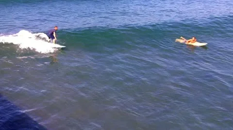 Venice Beach Surfer Rides Wave Past Waiting Surfer Stock Footage
