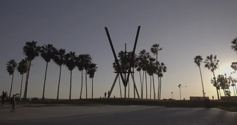 Venice Beach - Tracking Towards Main Courtyard Sculpture During Golden Hour Stock Footage 86242791