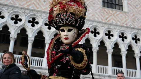 Venice - carnival masks are photographed with tourists in Piazza San Marco Stock Footage