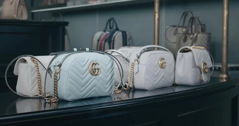 Venice, Italy - 01/28/2024: An array of stylish Gucci bags is elegantly Stock Footage 276608851