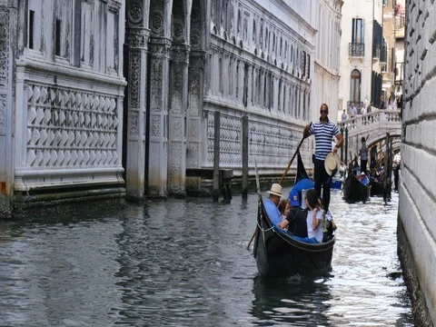 Venice Italy - gondola on canal with tourists Stock Footage