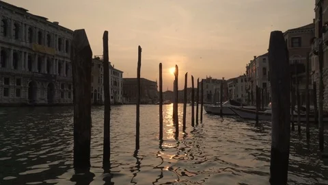 Venice mooring posts in silhouette at sunset Stock Footage 117835057
