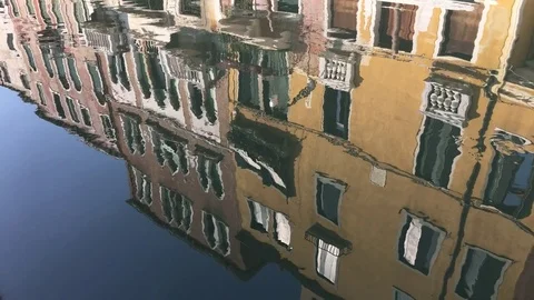 Venice water channels with reflection of buildings, destroyed by boat. 4K Stock Footage 72767941