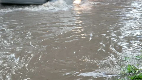 Venicles moving through road after downpour with deep water Stock-Footage 140766453