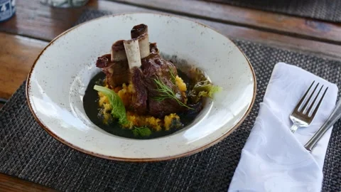 Venison ribs and mashed potatoes with cherry tomatoes and herbs. Stock Footage 147496750