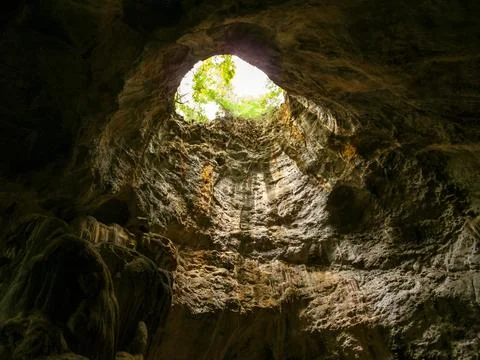 The vent inside the cave looked through until he could see the sky outside Stock Photos