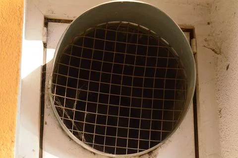 A vent with a mesh screen on it. Stock Photos